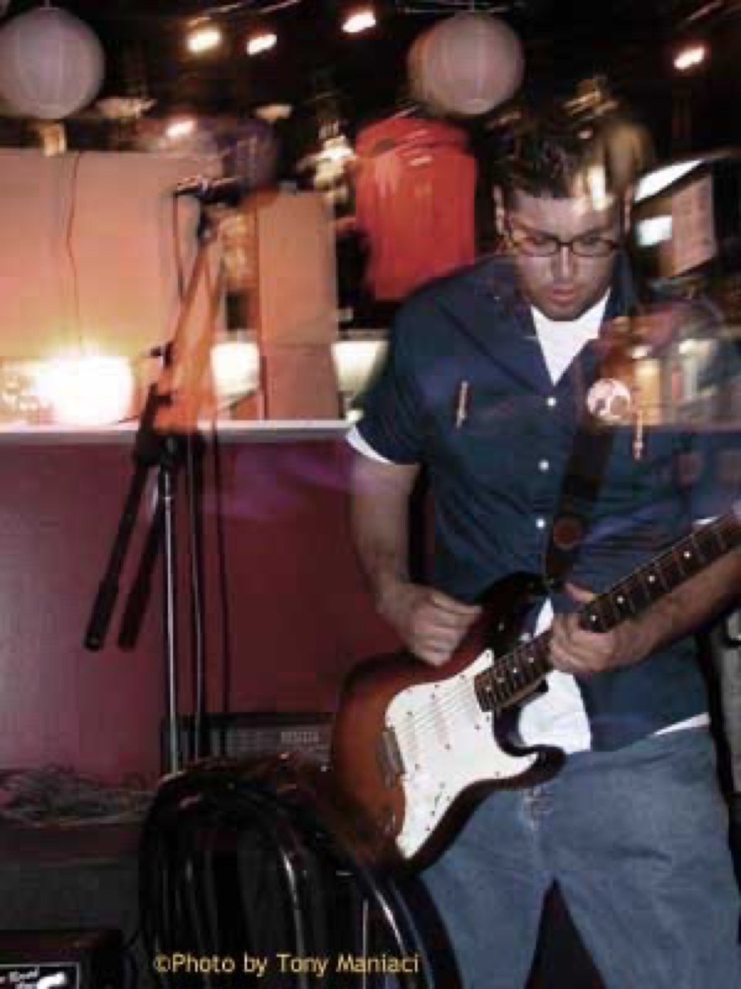 Eddie Garcia performing guitar in an earlier live venue.