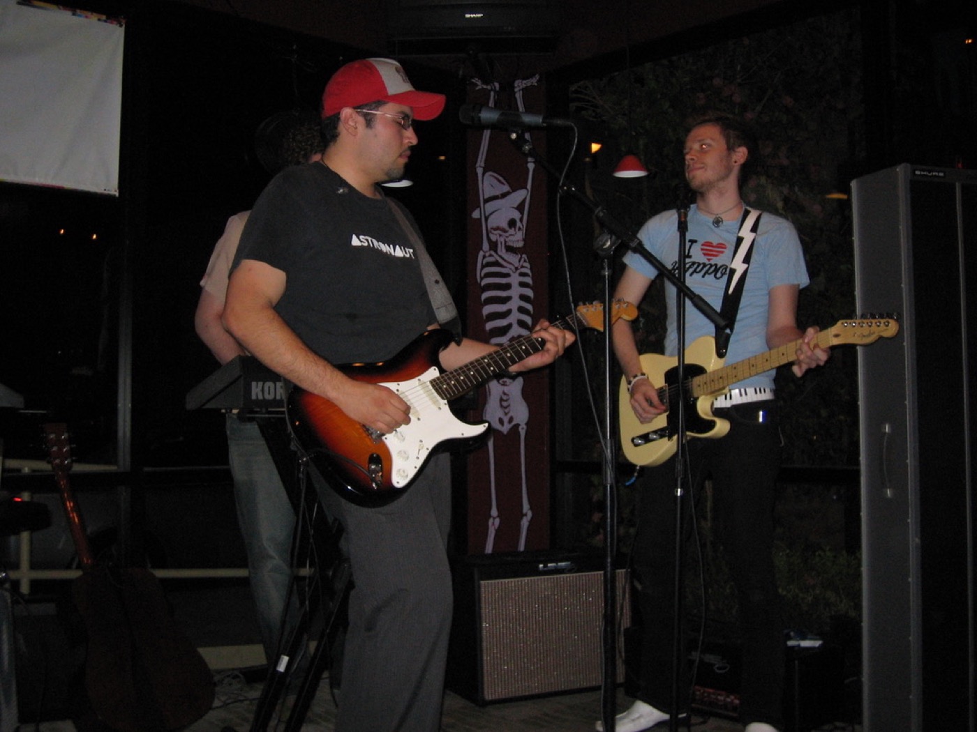 Eddie Garcia playing guitar onstage with another guitarist during the band years.