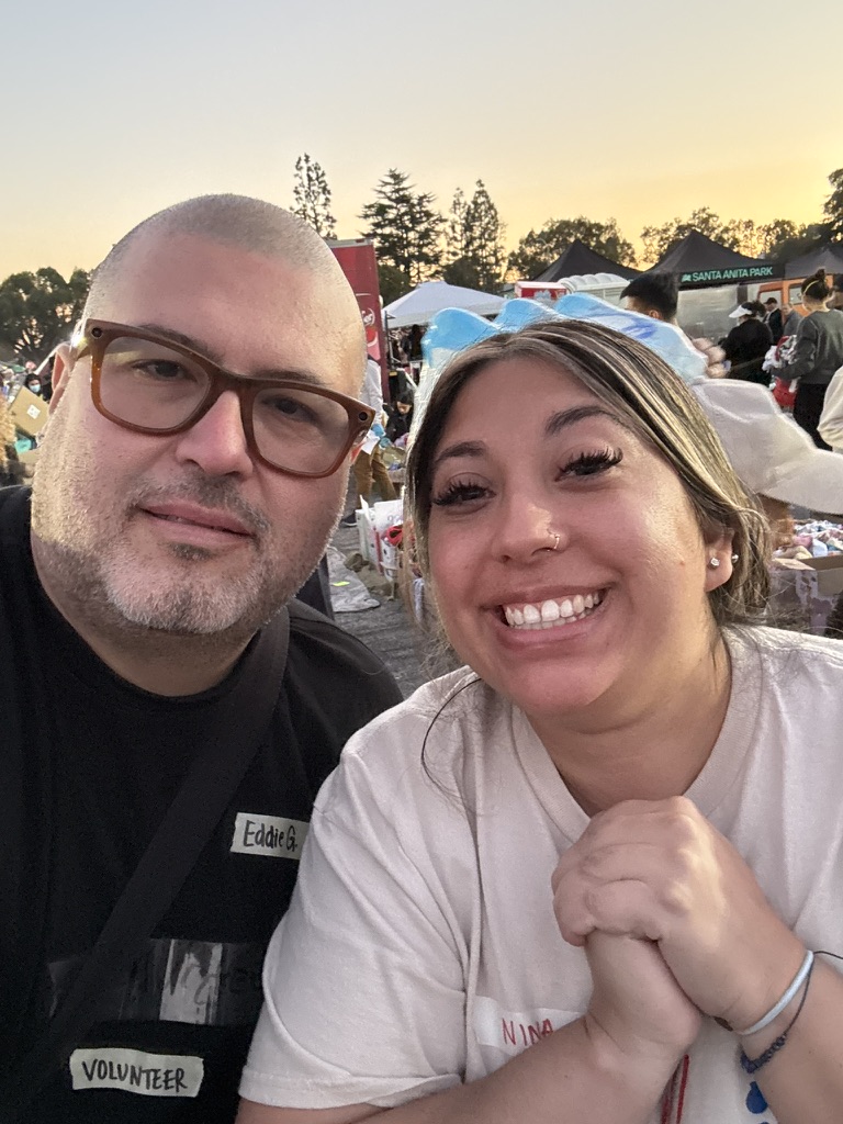 Eddie Garcia taking a daylight photo with another volunteer at the Santa Anita relief effort.