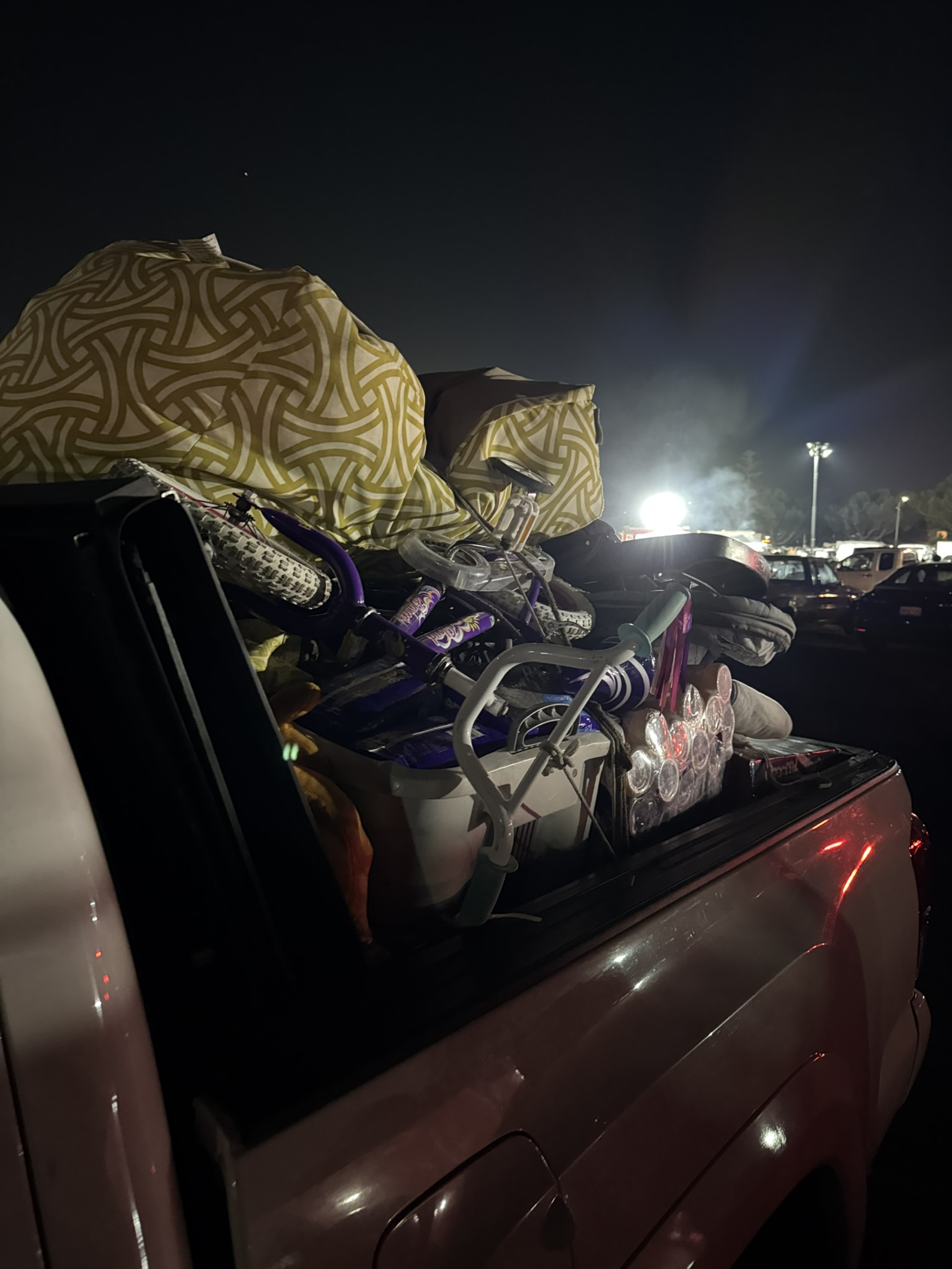 A truck loaded with donations arriving at the Santa Anita relief effort at night.